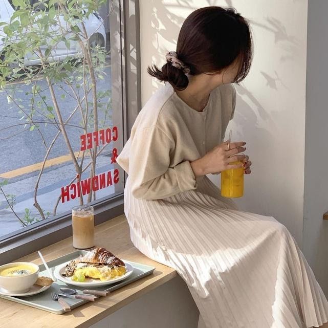 Rani sat by the window with her breakfast and her hair tied up with a scrunchie